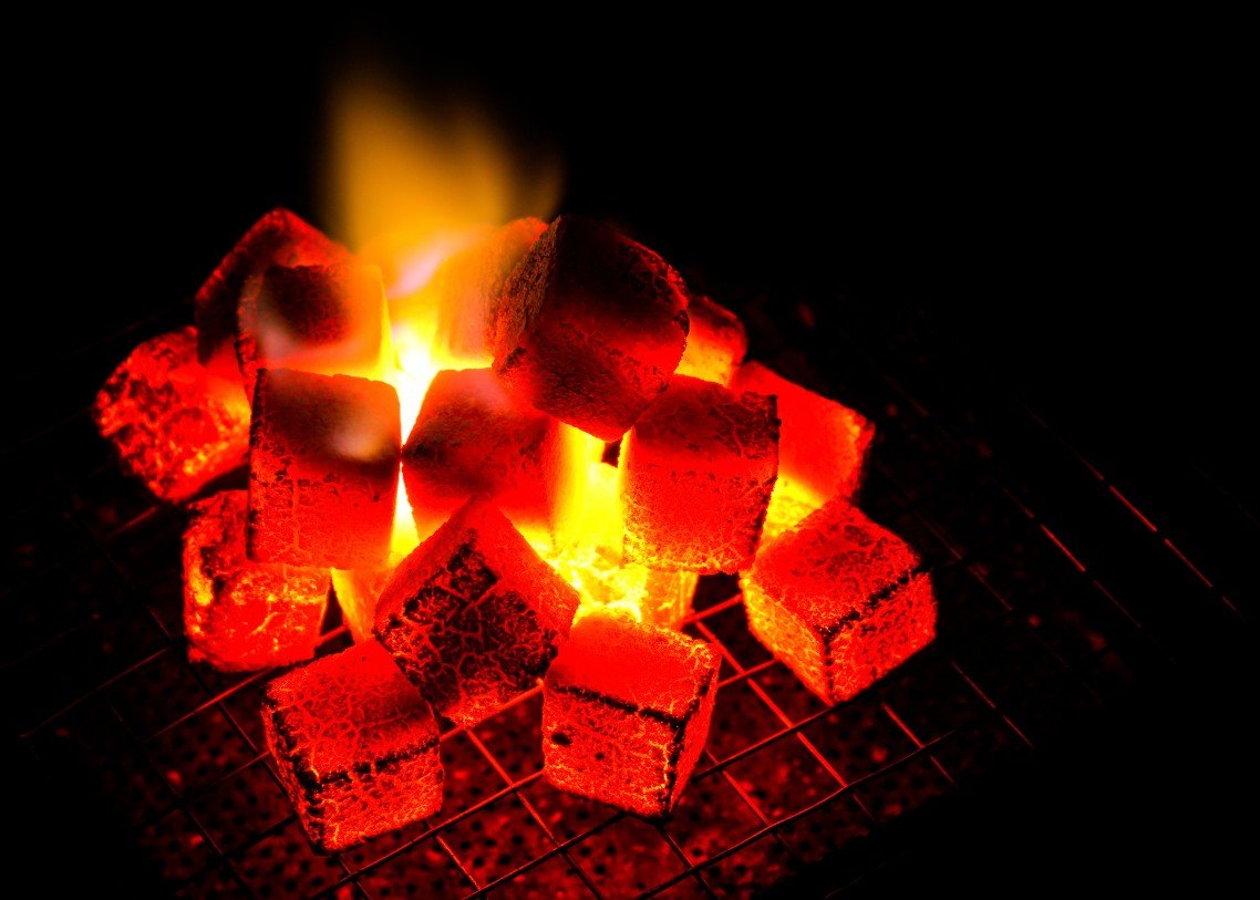 Coconut shell cube briquettes burning with a steady flame