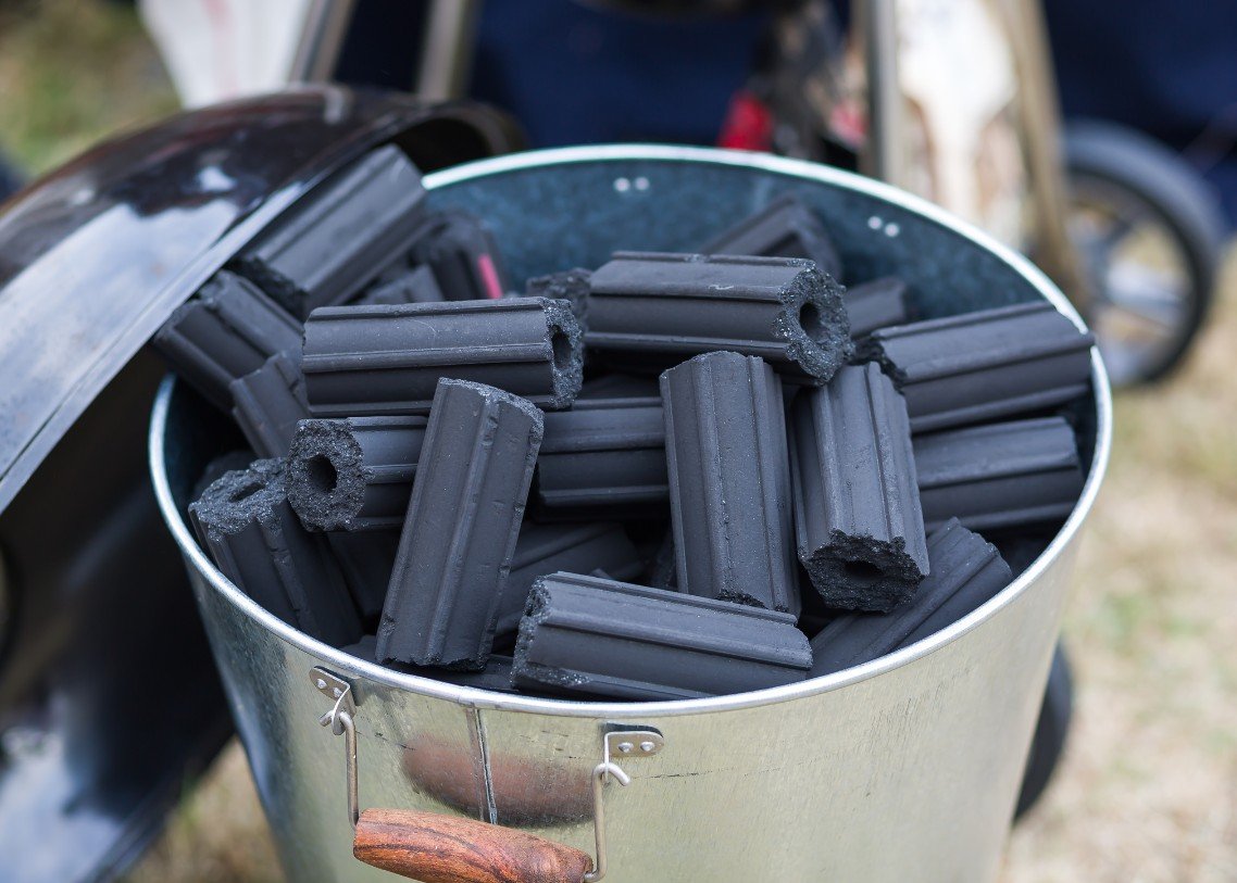 Hexagonal barbeque charcoal briquettes in a bucket
